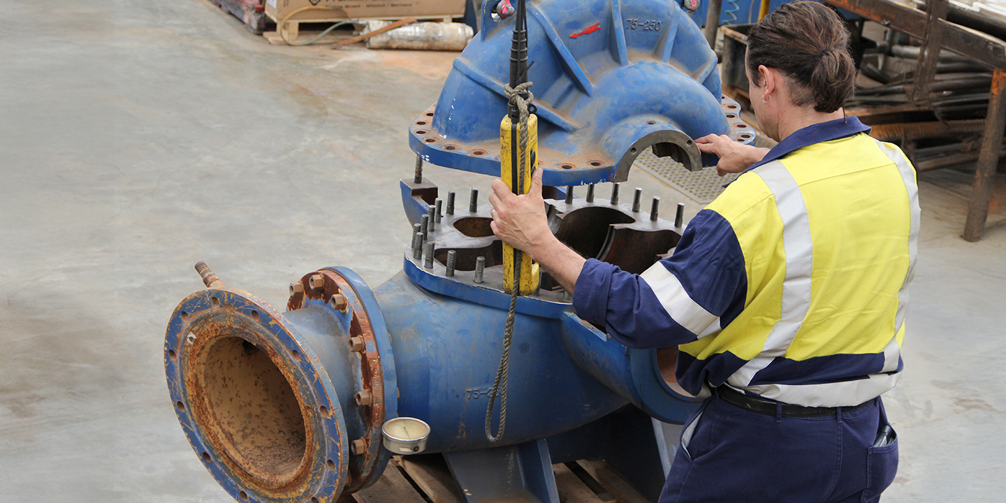 A technician working on a pump